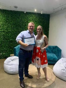 Ricky form Venturer Technology is smiling as he receives an award for service from his smiling customer Lana.